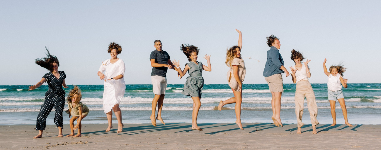 Coulson family jumping on a beach